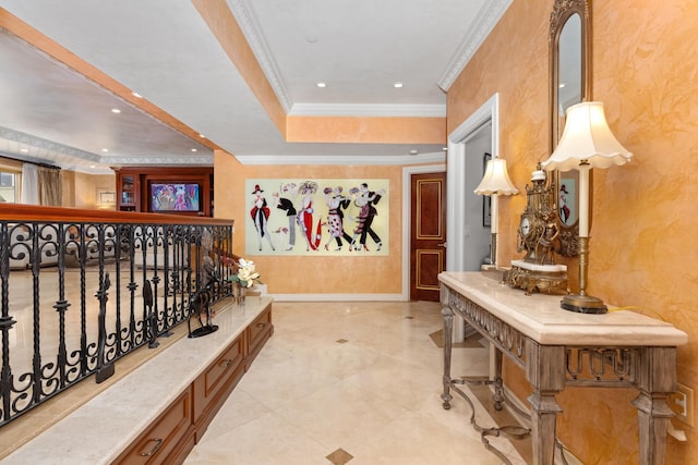 hallway with a raised ceiling and ornamental molding