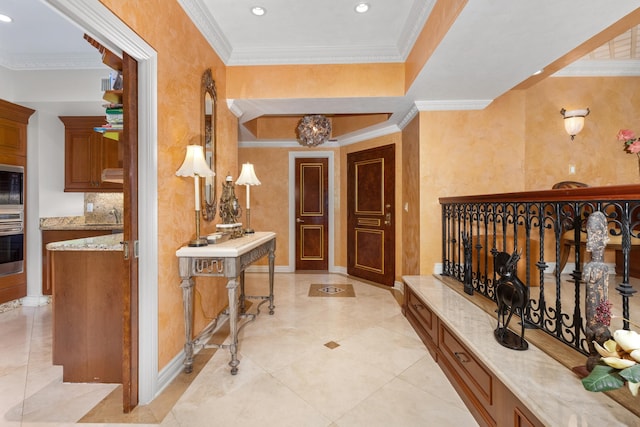 hall with ornamental molding and light tile patterned floors