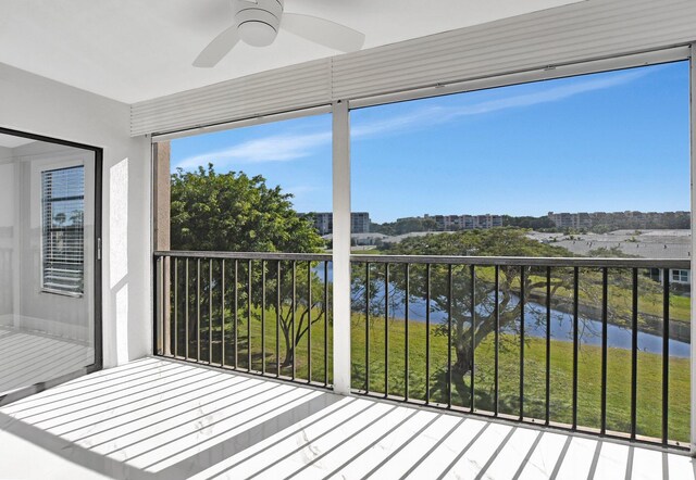 7076 Huntington Ln Unit 407, Delray Beach, FL 33446 - unfurnished sunroom with a view of city, a ceiling fan, and a water view