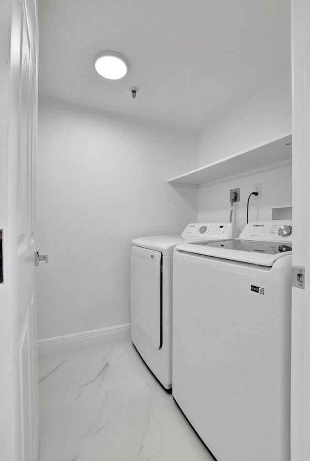 unfurnished room featuring ceiling fan, marble finish floor, and baseboards