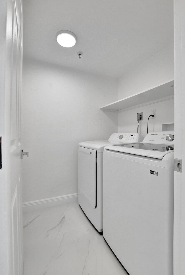 7076 Huntington Ln Unit 407, Delray Beach, FL 33446 - washroom with laundry area, washing machine and dryer, marble finish floor, and baseboards