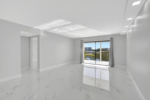 kitchen with a peninsula, white cabinetry, visible vents, and light stone counters