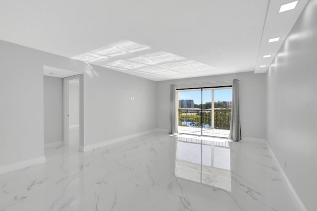 7076 Huntington Ln Unit 407, Delray Beach, FL 33446 - spare room featuring baseboards and marble finish floor