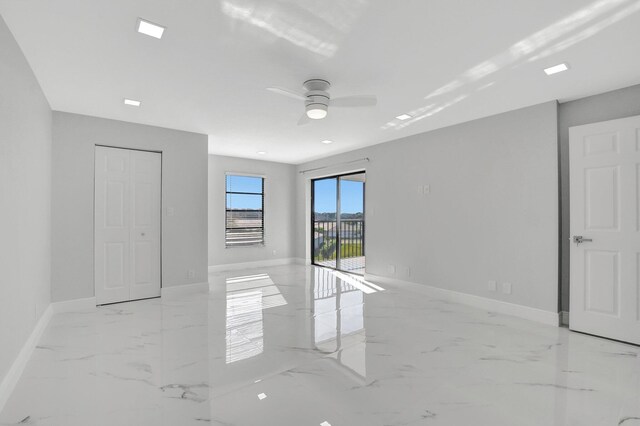 unfurnished living room featuring marble finish floor, visible vents, and baseboards