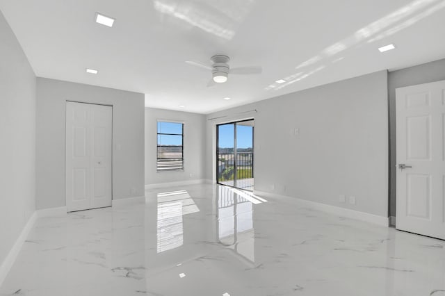 7076 Huntington Ln Unit 407, Delray Beach, FL 33446 - unfurnished room featuring baseboards, marble finish floor, and ceiling fan