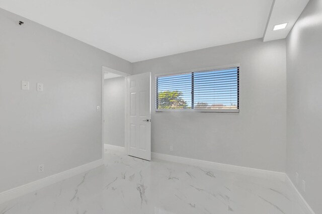 empty room with marble finish floor and baseboards