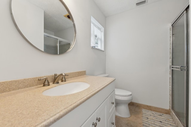 bathroom with toilet, tile patterned flooring, an enclosed shower, a textured ceiling, and vanity