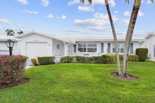 ranch-style home with a garage and a front yard