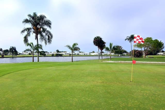 view of community with a lawn and a water view