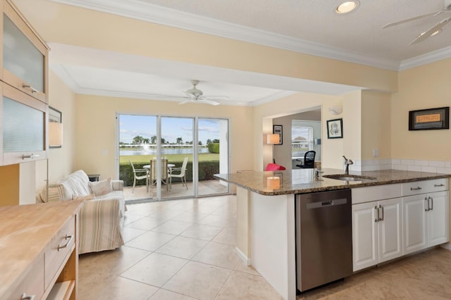 kitchen featuring white cabinetry, dark stone countertops, dishwasher, ornamental molding, and sink