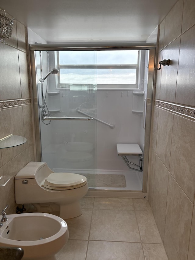 full bathroom featuring tile walls, toilet, a stall shower, a bidet, and tile patterned flooring