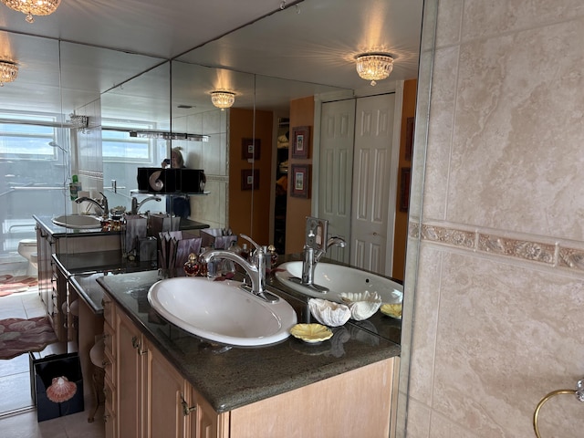 bathroom featuring tile patterned flooring and vanity