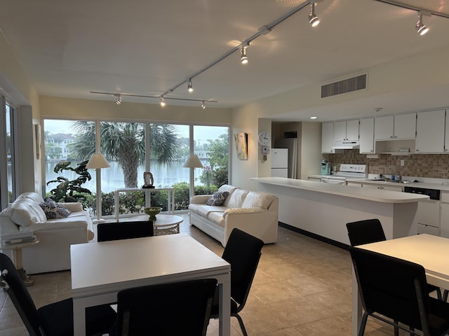 dining area featuring light tile patterned floors, visible vents, and track lighting