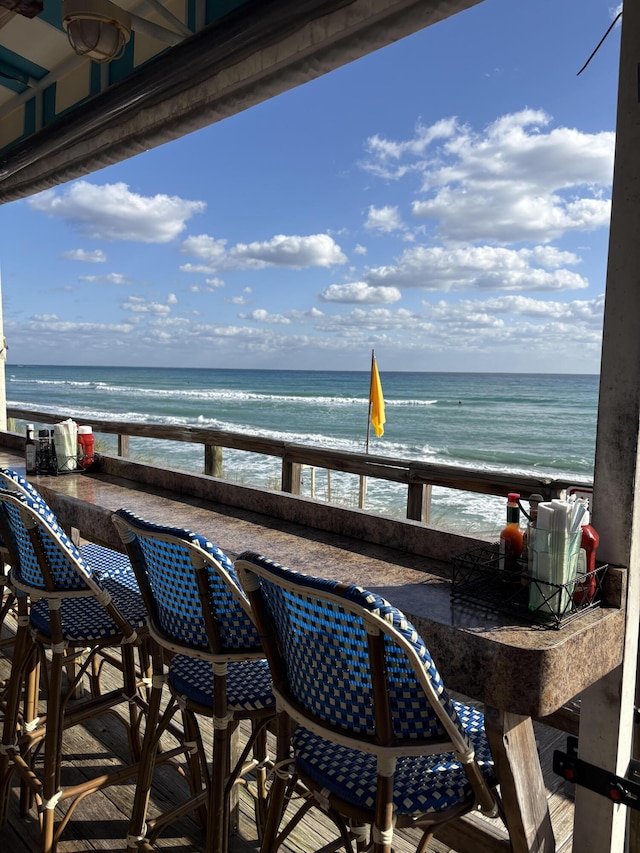 balcony with a water view and a beach view