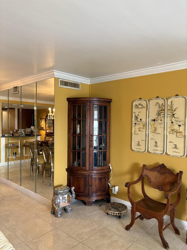 sitting room with crown molding, light tile patterned floors, visible vents, a chandelier, and baseboards