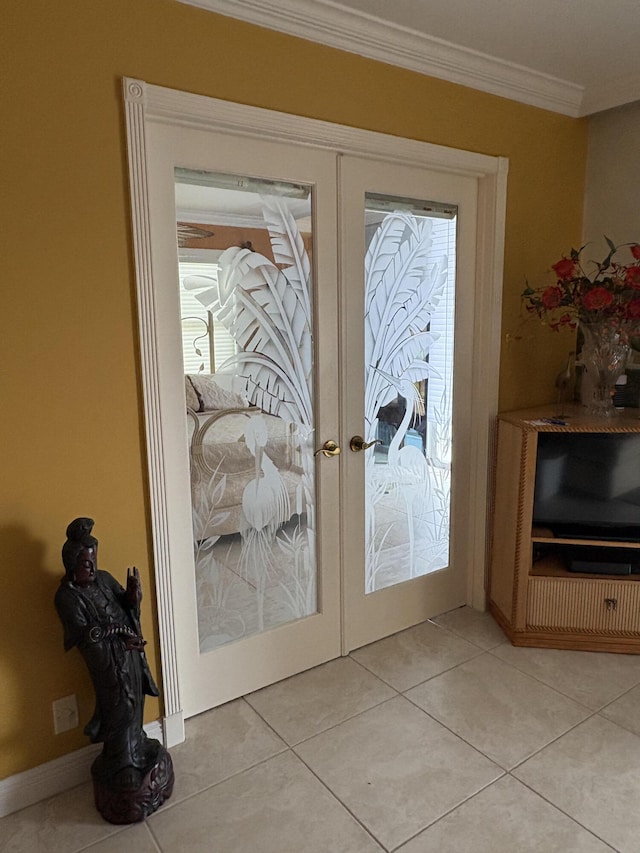 entryway featuring light tile patterned floors, baseboards, ornamental molding, and french doors