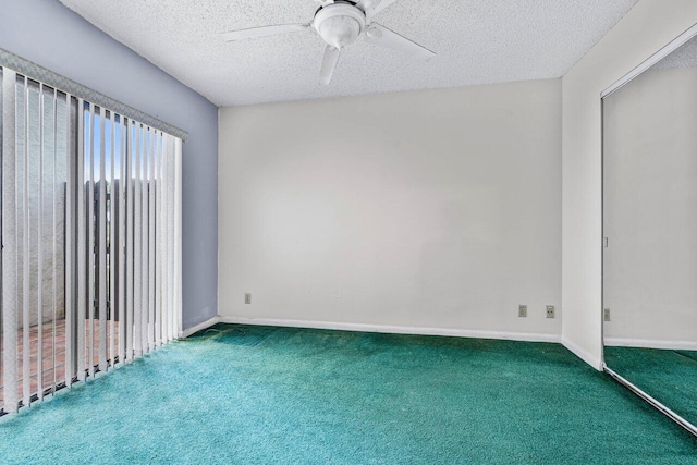 empty room with carpet, ceiling fan, and a textured ceiling