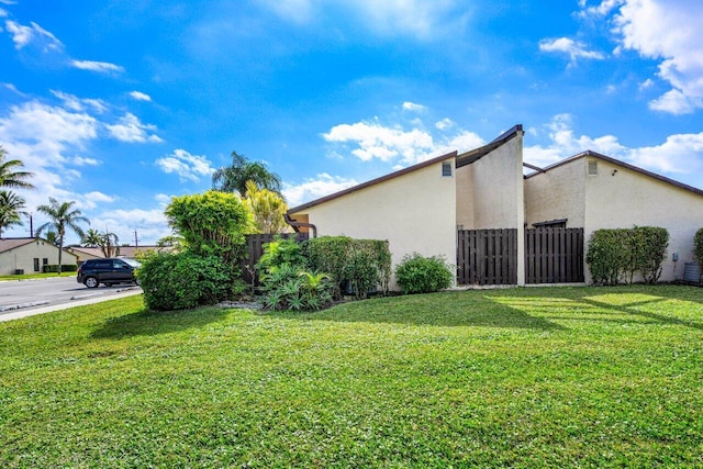 view of property exterior with a lawn