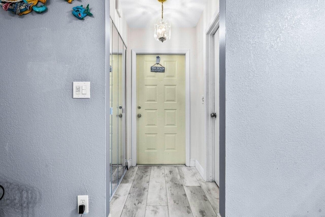 interior space featuring a chandelier and light hardwood / wood-style flooring