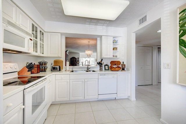 kitchen featuring sink, decorative light fixtures, white cabinets, white appliances, and light tile patterned floors