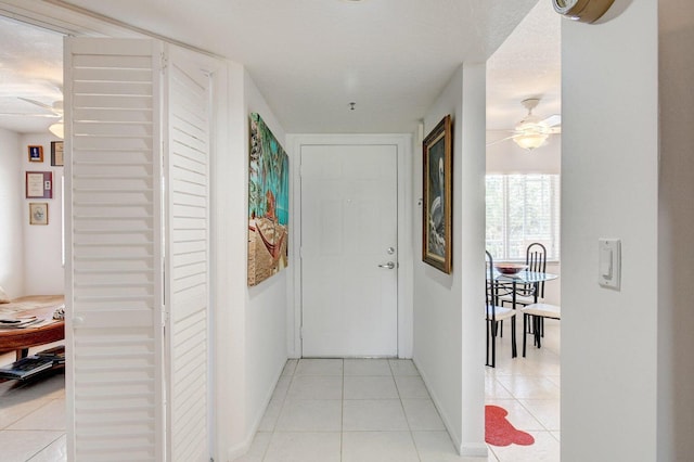 corridor featuring light tile patterned flooring