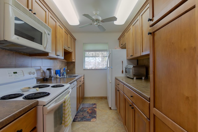 kitchen featuring sink, white appliances, decorative backsplash, and ceiling fan