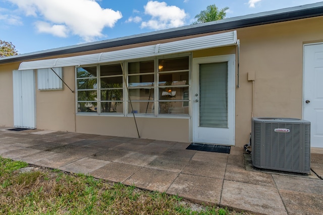 property entrance with central AC and a patio area