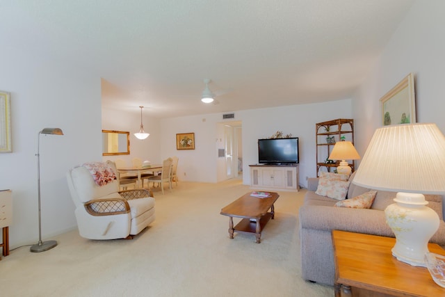 living room featuring ceiling fan and carpet floors