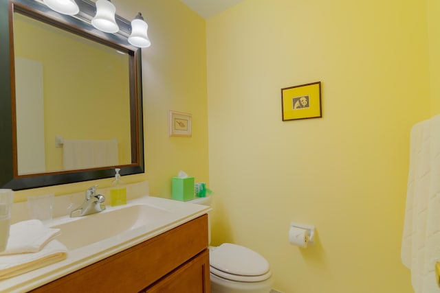 bathroom featuring toilet and vanity