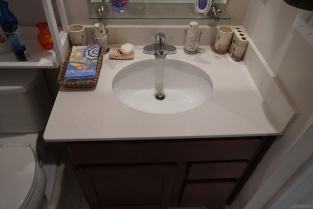 bathroom featuring toilet and vanity