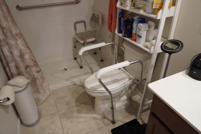 bathroom with toilet, a shower with shower curtain, vanity, and tile patterned floors