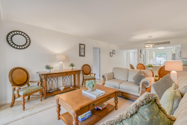 living room featuring a notable chandelier