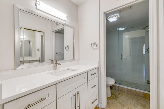 bathroom featuring toilet, vanity, and an enclosed shower