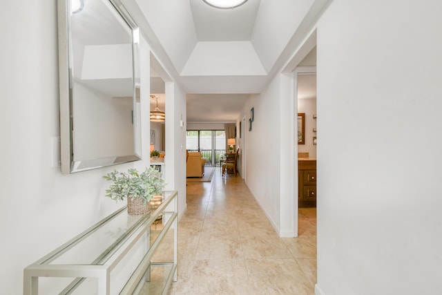 corridor with vaulted ceiling