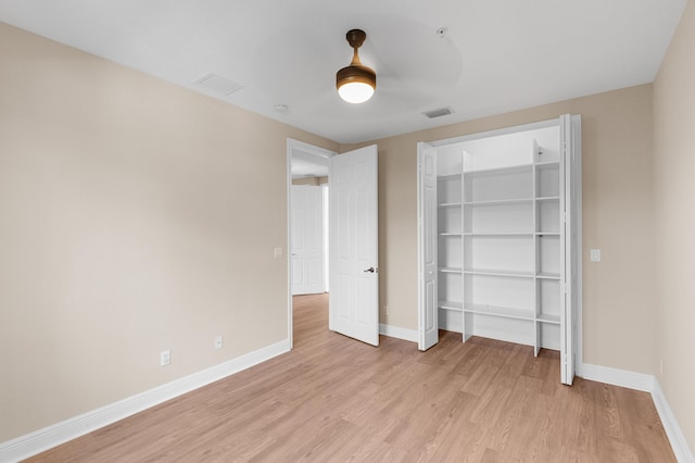 3016 Waterside Cir, Boynton Beach, FL 33435 - unfurnished bedroom featuring light wood-style floors, baseboards, a closet, and ceiling fan
