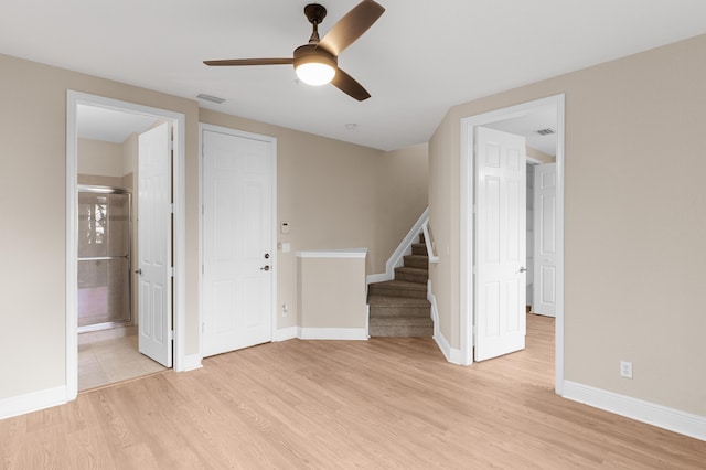 3016 Waterside Cir, Boynton Beach, FL 33435 - unfurnished room with a ceiling fan, light wood-style floors, stairs, and baseboards