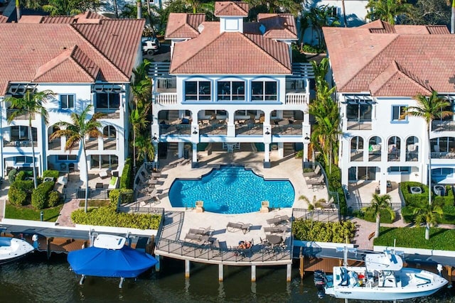 3016 Waterside Cir, Boynton Beach, FL 33435 - back of house featuring a balcony, a water view, a tiled roof, and an outdoor pool