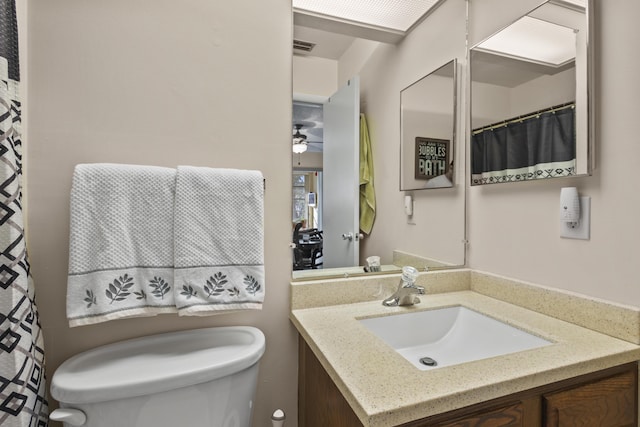 bathroom featuring vanity, ceiling fan, and toilet