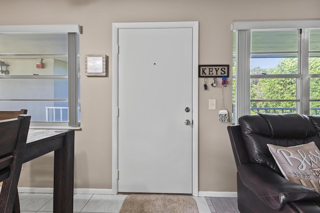 foyer entrance with light tile patterned flooring