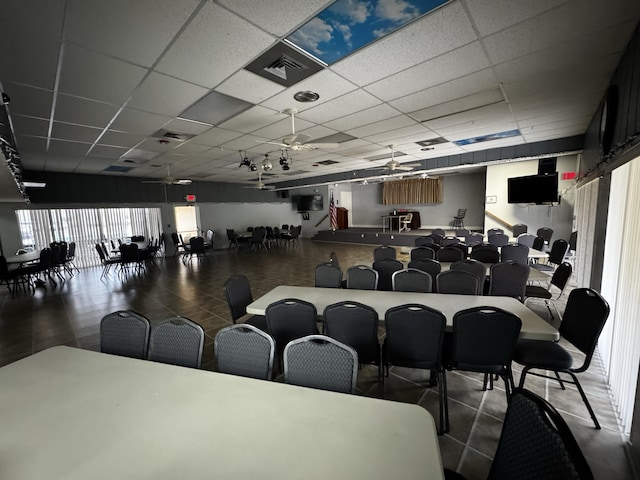 interior space featuring a paneled ceiling and ceiling fan