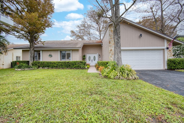 view of front of house featuring a front lawn and a garage