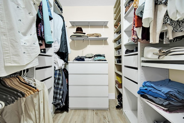 walk in closet with light wood-type flooring