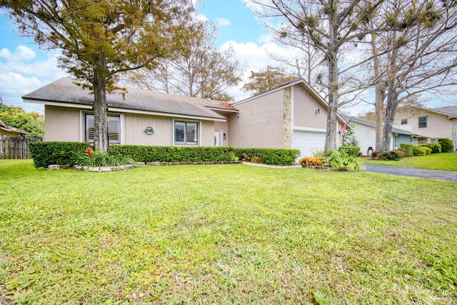 ranch-style house with a garage and a front yard