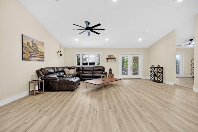 living room featuring lofted ceiling, light hardwood / wood-style flooring, and french doors