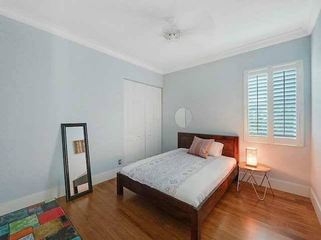 bedroom featuring hardwood / wood-style flooring, a closet, and ornamental molding