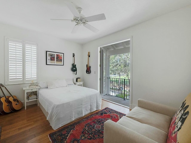 bedroom with multiple windows, access to exterior, ceiling fan, and hardwood / wood-style flooring