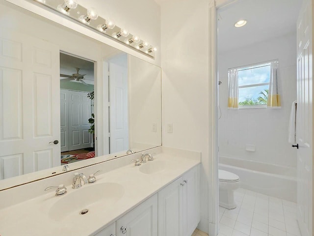 bathroom featuring double vanity, tile patterned flooring, a sink, and toilet