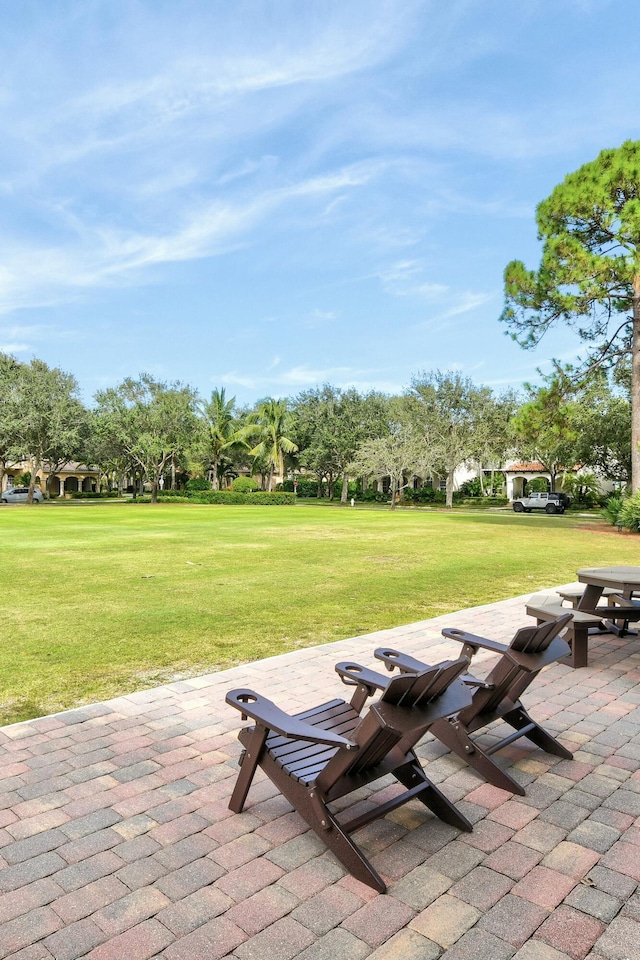 view of community featuring a yard and a patio