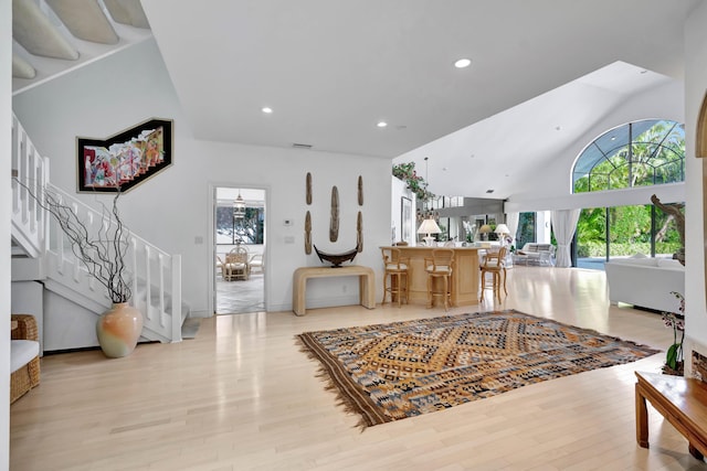 entryway featuring high vaulted ceiling and light hardwood / wood-style flooring