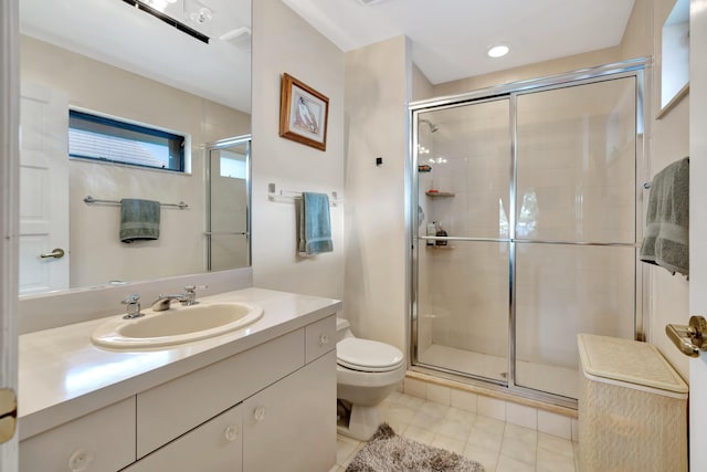 bathroom featuring tile patterned floors, toilet, vanity, and an enclosed shower